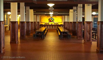 empty beer hall with wooden tables and benches for drinking