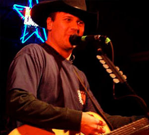 Roger Creager singing into microphone